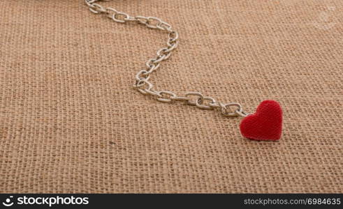 Little sized books attached to a heart with a chain