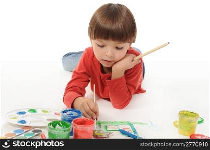 little smiling boy draws paint. Isolated on white background