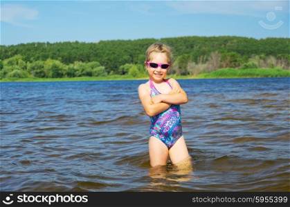 Little smiling girl at river