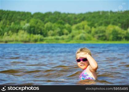 Little smiling girl at river