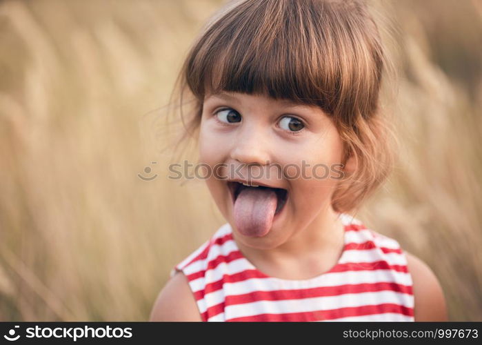 little smiling girl at the outdoor. Fun summer