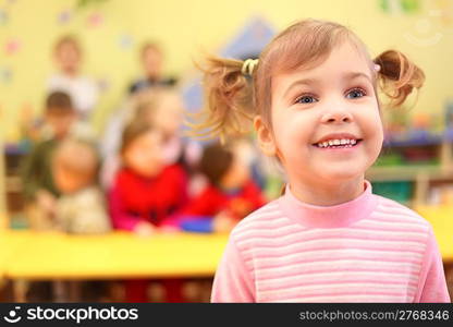 Little smiling girl in kindergarten