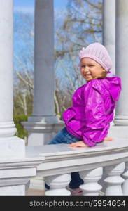 Little smiling girl on bench at park