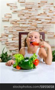 Little smiling girl with vegetables at light room