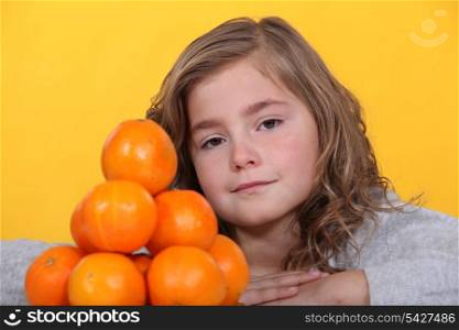 little stood with pile of oranges