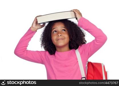 Little student girl with a book on her head isolated on a white background