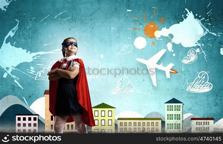 Little superhero. Cute girl of school age wearing super hero costume
