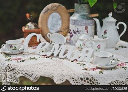 Little table with flowers and beautiful things in a garden.. Decorative interior outdoors 2154.. Decorative interior outdoors 2154.