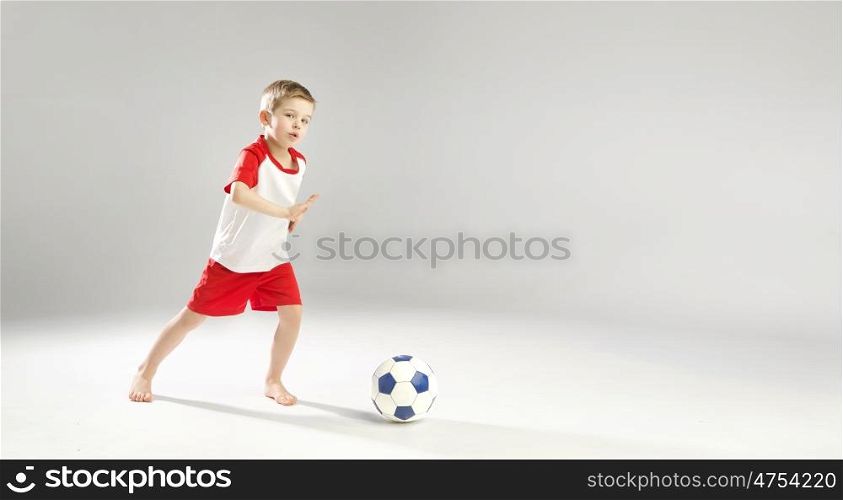 Little talented boy playing soccer