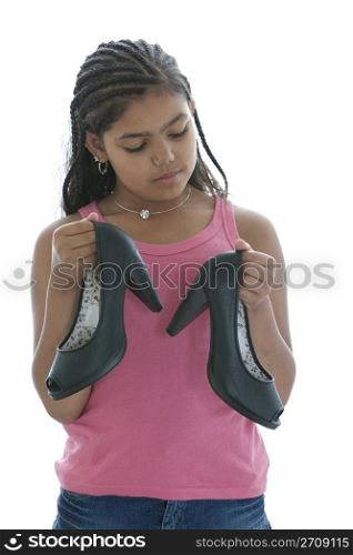 Little Teenage Girl Is Looking At High Heels Shoes On White Background