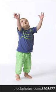Little Toddler Boy Is Reaching With His Arms Above