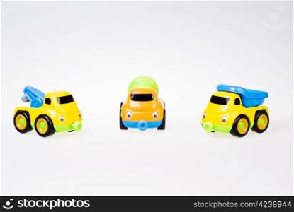 Little toy cars team on white background