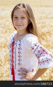 little ukrainian smiling girl in a wheat field