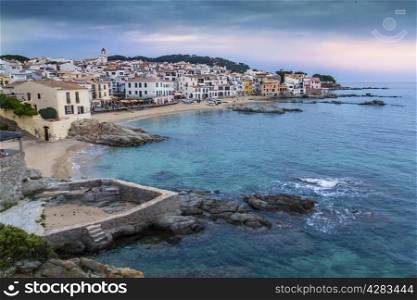 Little village of Girona (Spain) called Callela de Parafrugell, with a beautiful sky and sea, and white houses at the coast.
