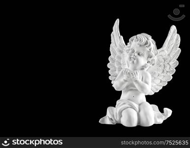 Little white guardian angel isolated on black background. Christmas decoration