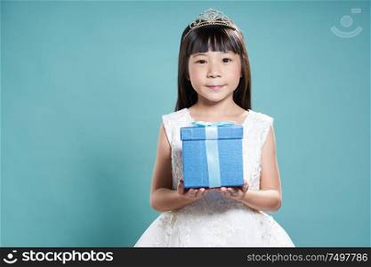 Little young asian girl holding present box , celebrating and festival concept .