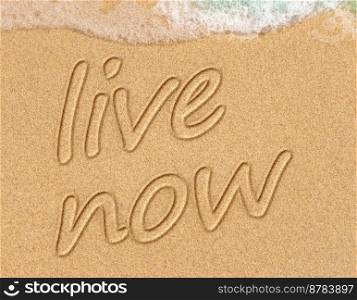 live now, mindfulness concept, text written on the sand