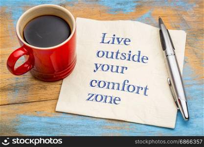 Live outside your comfort zone - inspirational handwriting on a napkin with a cup of coffee
