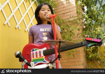 live rock concert at home one little girl singing and playing guitar