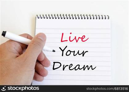 Live your dream text concept write on notebook