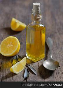 Liver Detox with olive oil and lemon fruits on the wooden table