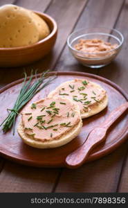 Liverwurst spread on bun with chives photographed with natural light (Selective Focus, Focus one third into the bun)