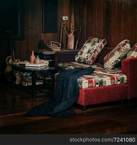 Living area with sofa, table ,wood floor and wood wall, selective focus
