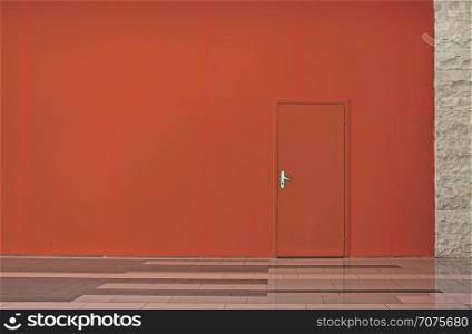 Living Coral color wall with a door. Horizontal minimalist background