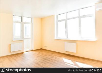Living room interior. Living interior of empty room with wooden floor and light from the big white isolated windows