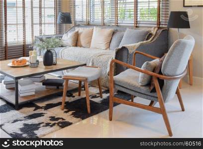 living room interior with pillows on sofa and decorative wooden table with lamp
