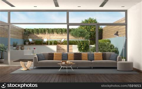 Living room of a modern villa with colorful sofa and garden on background - 3d rendering. Living room of a modern villa with garden on background