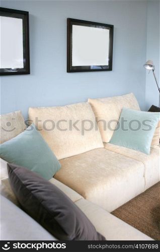 Living room with cream sofa, soft blue wall, interior design