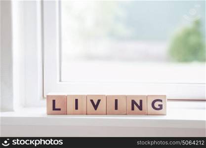 Living sign in a bright window in a room