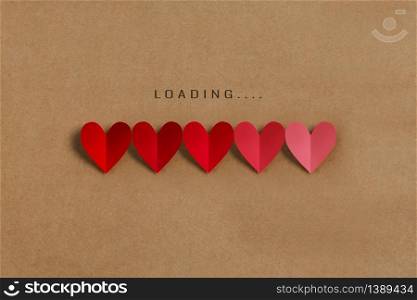 Loading progress bar with red and pink hearts on brown paper background. Valentine?s day, Love, Life concepts.