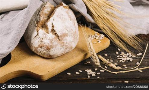 loaf bread ear wheat dark wooden background
