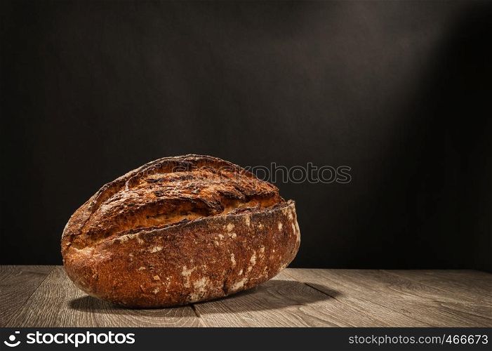loaf of bread on a table on dark background