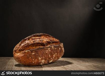 loaf of bread on a table on dark background