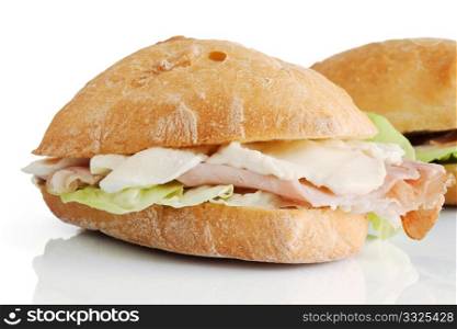 loaf of bread with ham, mozzarella and lettuce isolated