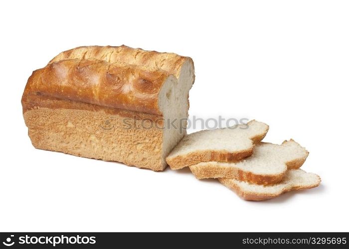 Loaf of bread with slices on white background