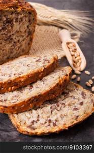 Loaf of fresh baked wholegrain bread for breakfast and ears of rye or wheat grain. Loaf of wholegrain bread for breakfast and ears of rye or wheat grain