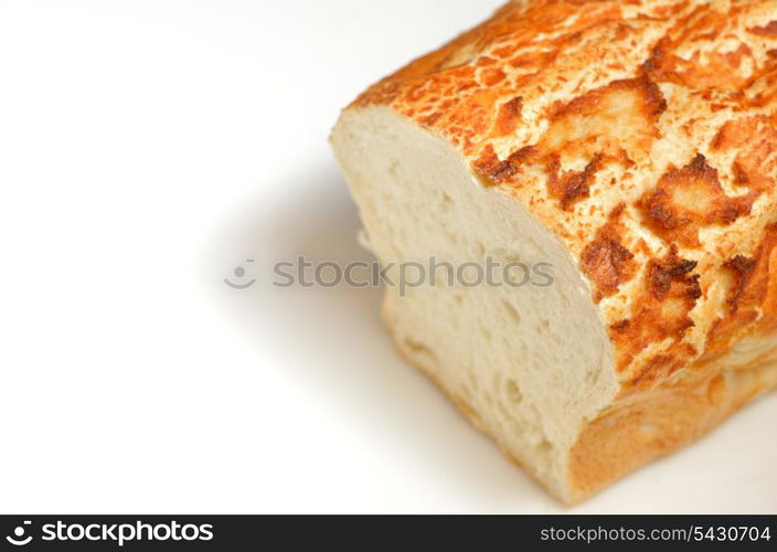 loaf of freshly baked bread with an end sliced off on white background