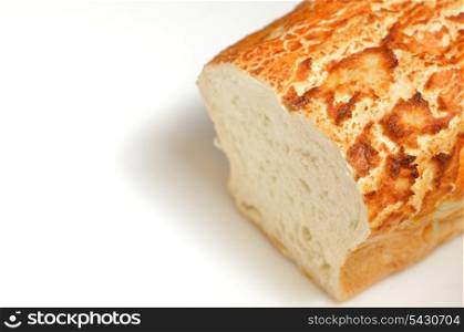 loaf of freshly baked bread with an end sliced off on white background