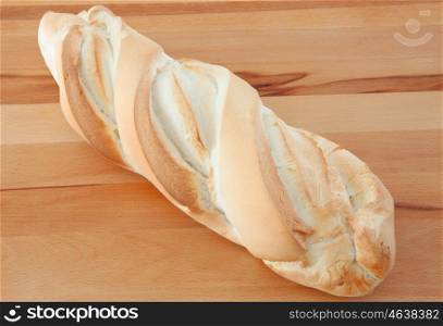 Loaf of white bread on wooden board