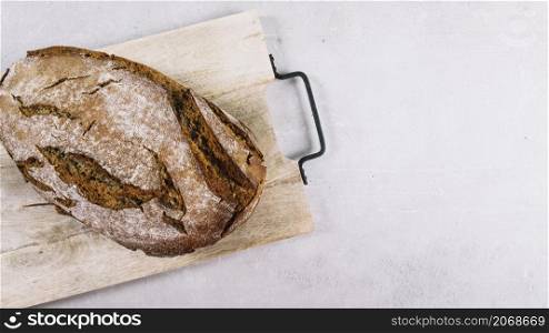 loaf rustic baked bread chopping board white background