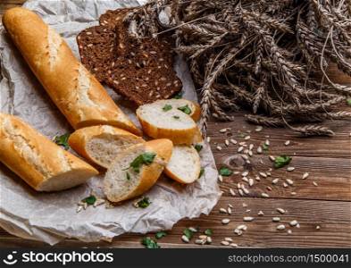 Loaf with grain bread on table with wheat, sunflower seeds. Loaf, grain bread on table