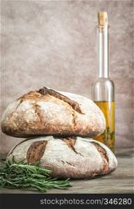 Loaves of bread with olive oil and fresh rosemary