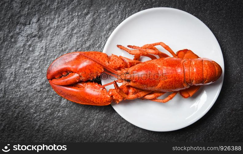 Lobster on white plate with dark background / seafood shrimp prawn