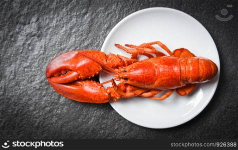 Lobster on white plate with dark background / seafood shrimp prawn