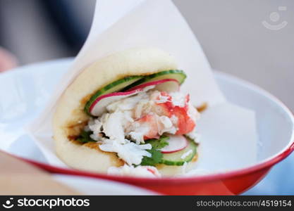 Lobster roll sandwich in outdoor restaurant