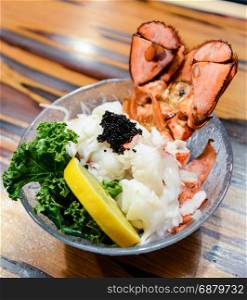 Lobster Sashimi with black tobiko (flying fish roe), lemon and kale